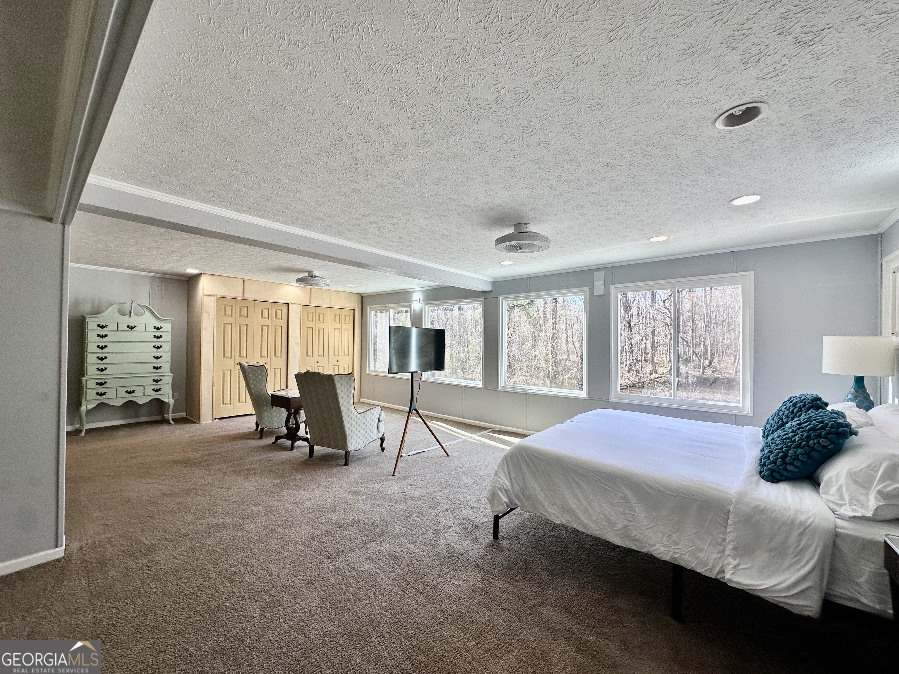 326 Turkey Run Dublin, GA 31021 - Photo 46 of 114 a spacious bedroom with a bed a chair and next to a window