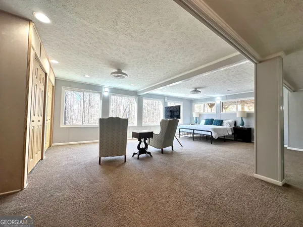 a living room with furniture window and a flat screen tv