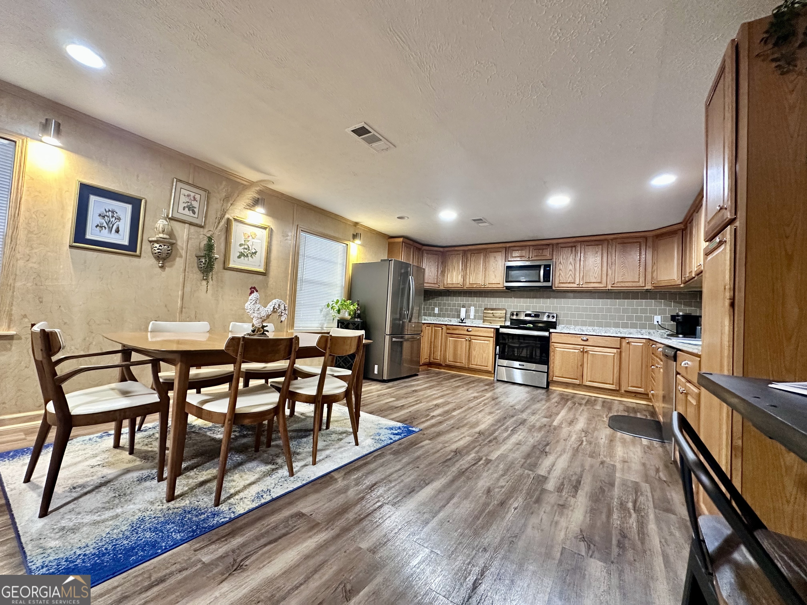 326 Turkey Run Dublin, GA 31021 - Photo 55 of 114 a kitchen with a dining table chairs and refrigerator