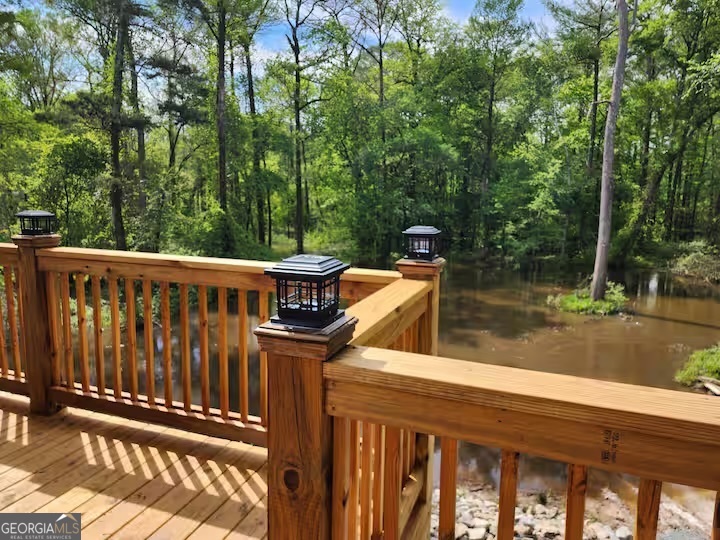 326 Turkey Run Dublin, GA 31021 - Photo 62 of 114 a view of a wooden deck with chairs and a yard