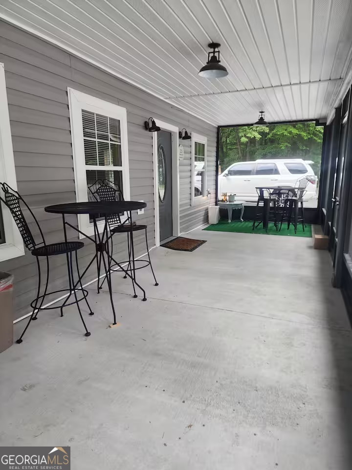 326 Turkey Run Dublin, GA 31021 - Photo 8 of 114 a view of a patio with table and chairs with wooden floor and plants