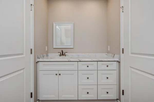 a bathroom with a sink and vanity