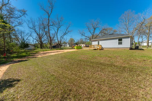 a view of a large house with a yard and a large tree