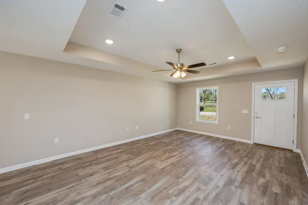 wooden floor in an empty room with a window