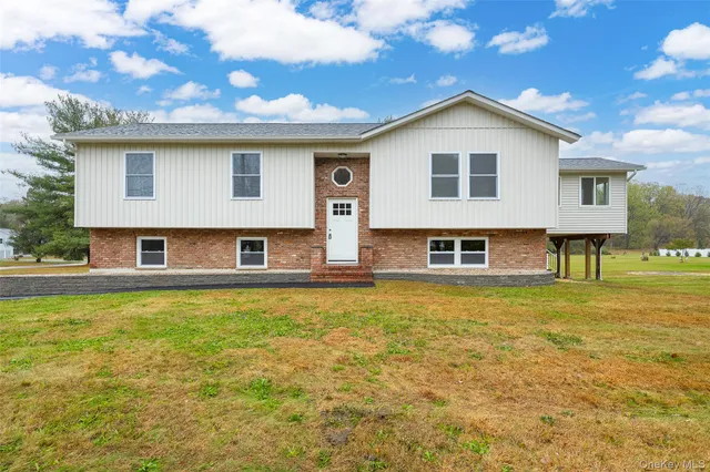 a view of a house with pool and a yard