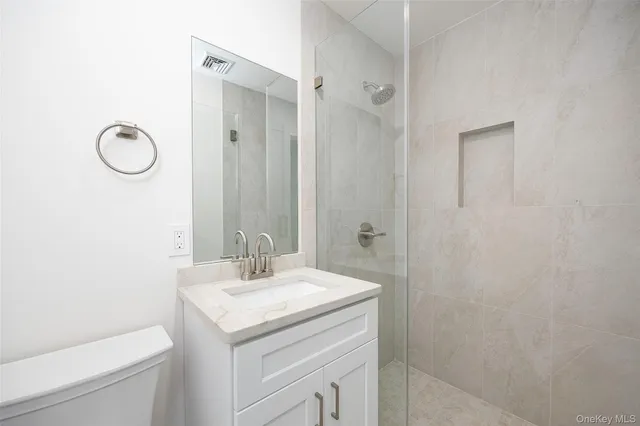 a bathroom with a sink toilet and vanity