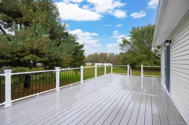 a view of a balcony with wooden floor and fence