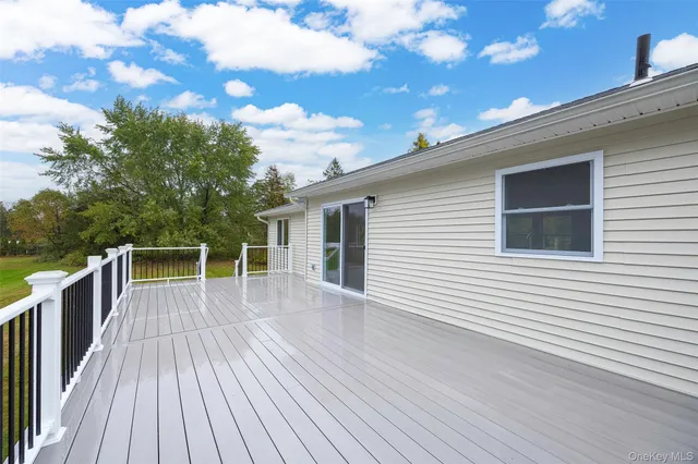 a view of backyard with a deck and wooden floor