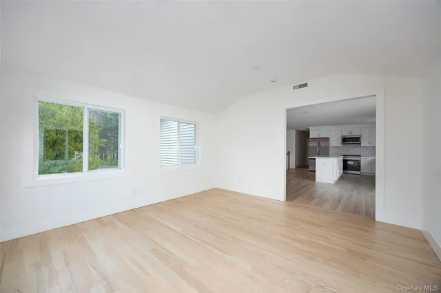 a view of a livingroom with wooden floor and a window