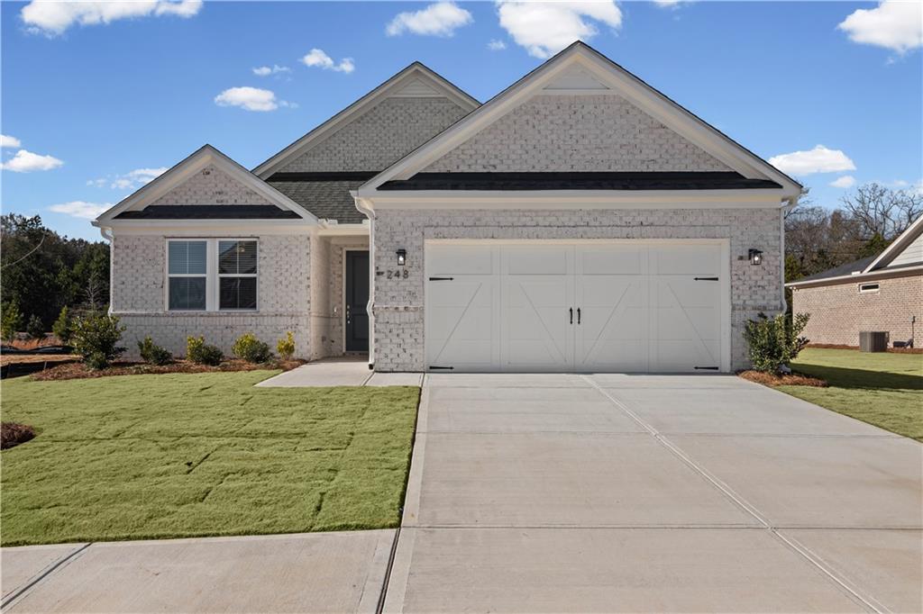 248 Nesta Grove Locust Grove, GA 30248 - Photo 1 of 40 a front view of a house with a yard and garage