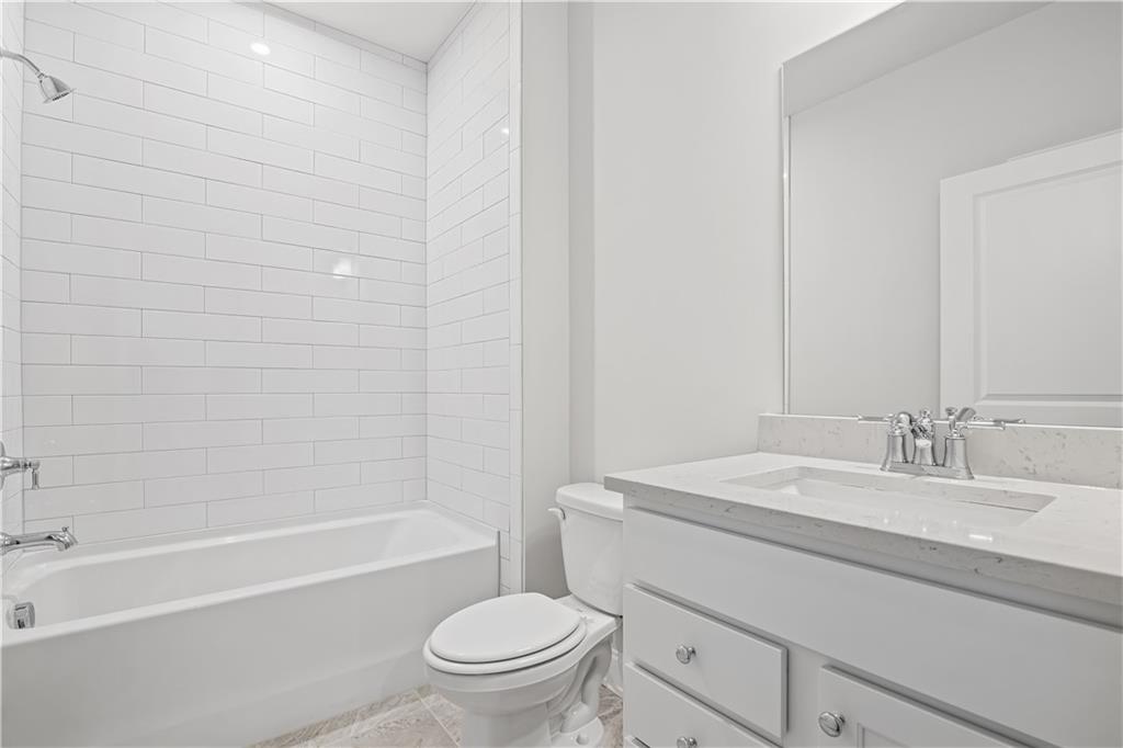 248 Nesta Grove Locust Grove, GA 30248 - Photo 23 of 40 a bathroom with a sink a toilet and a bathtub