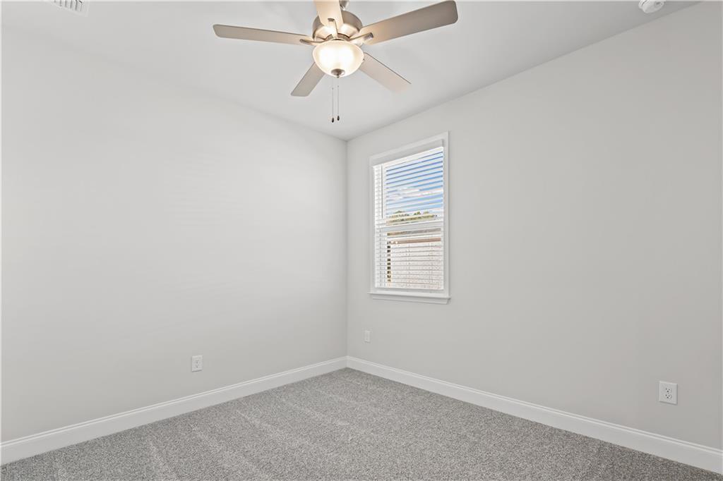 248 Nesta Grove Locust Grove, GA 30248 - Photo 25 of 40 an empty room with a window and a fan