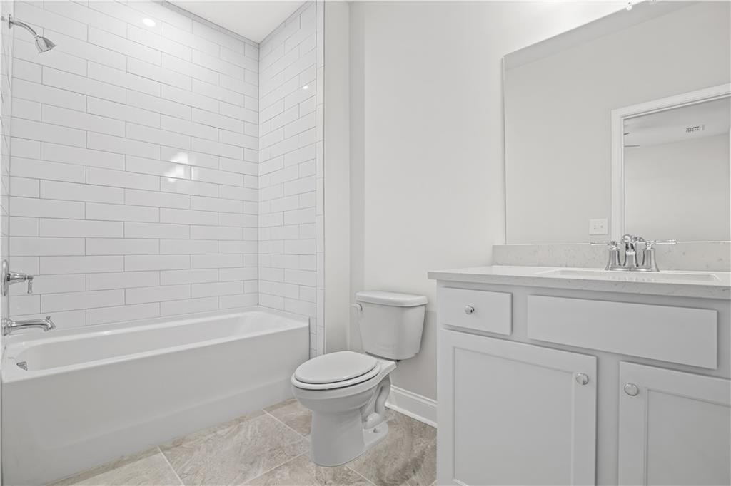 248 Nesta Grove Locust Grove, GA 30248 - Photo 27 of 40 a bathroom with a sink a toilet and shower