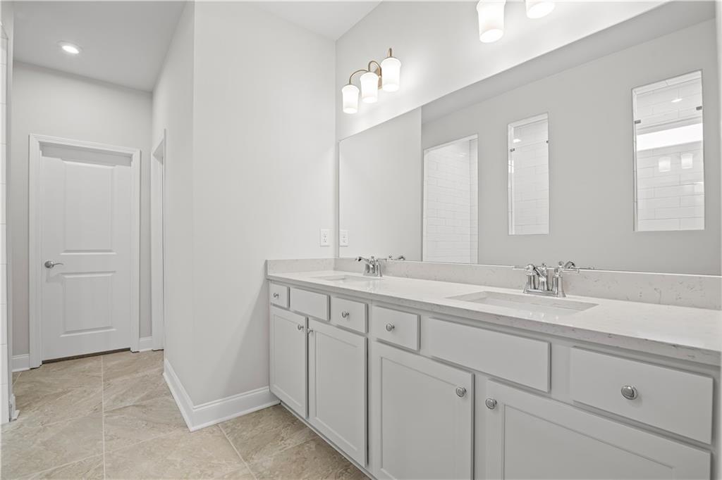 248 Nesta Grove Locust Grove, GA 30248 - Photo 31 of 40 a bathroom with 2 sink and a mirror