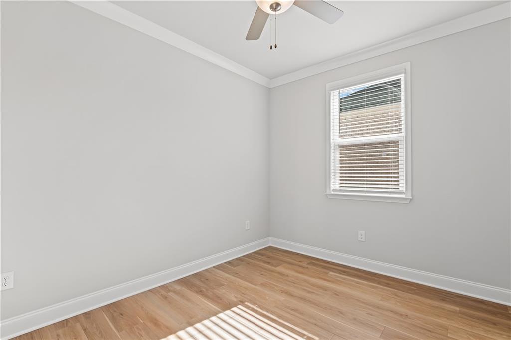 248 Nesta Grove Locust Grove, GA 30248 - Photo 7 of 40 a view of an empty room with wooden floor and a window