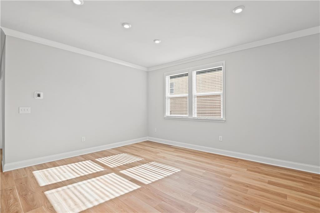 248 Nesta Grove Locust Grove, GA 30248 - Photo 10 of 40 a view of an empty room with wooden floor and a window