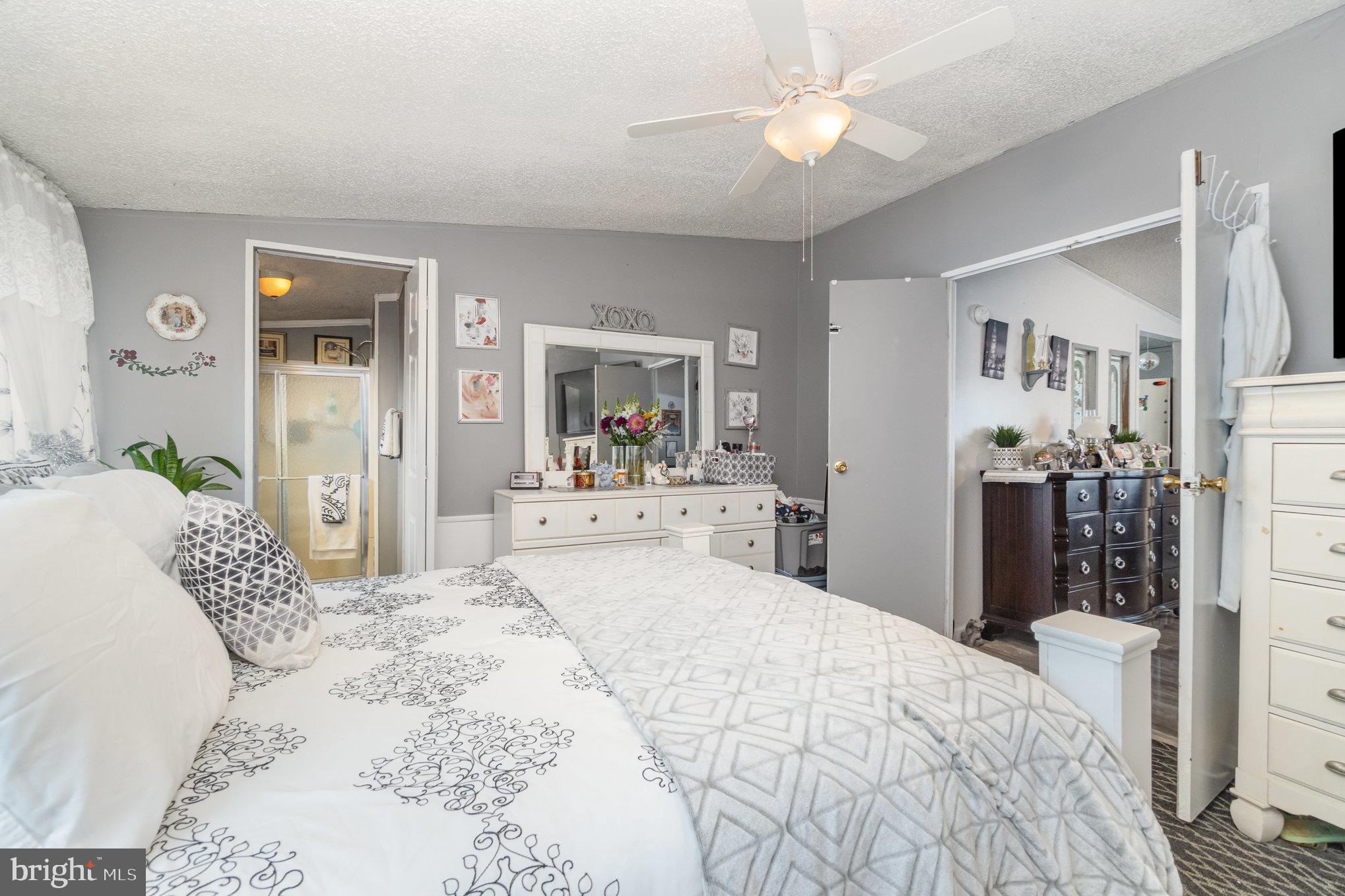 90 Penn Valley Village Lititz, PA 17543 - Photo 13 of 26 a bedroom with a bed and a chandelier