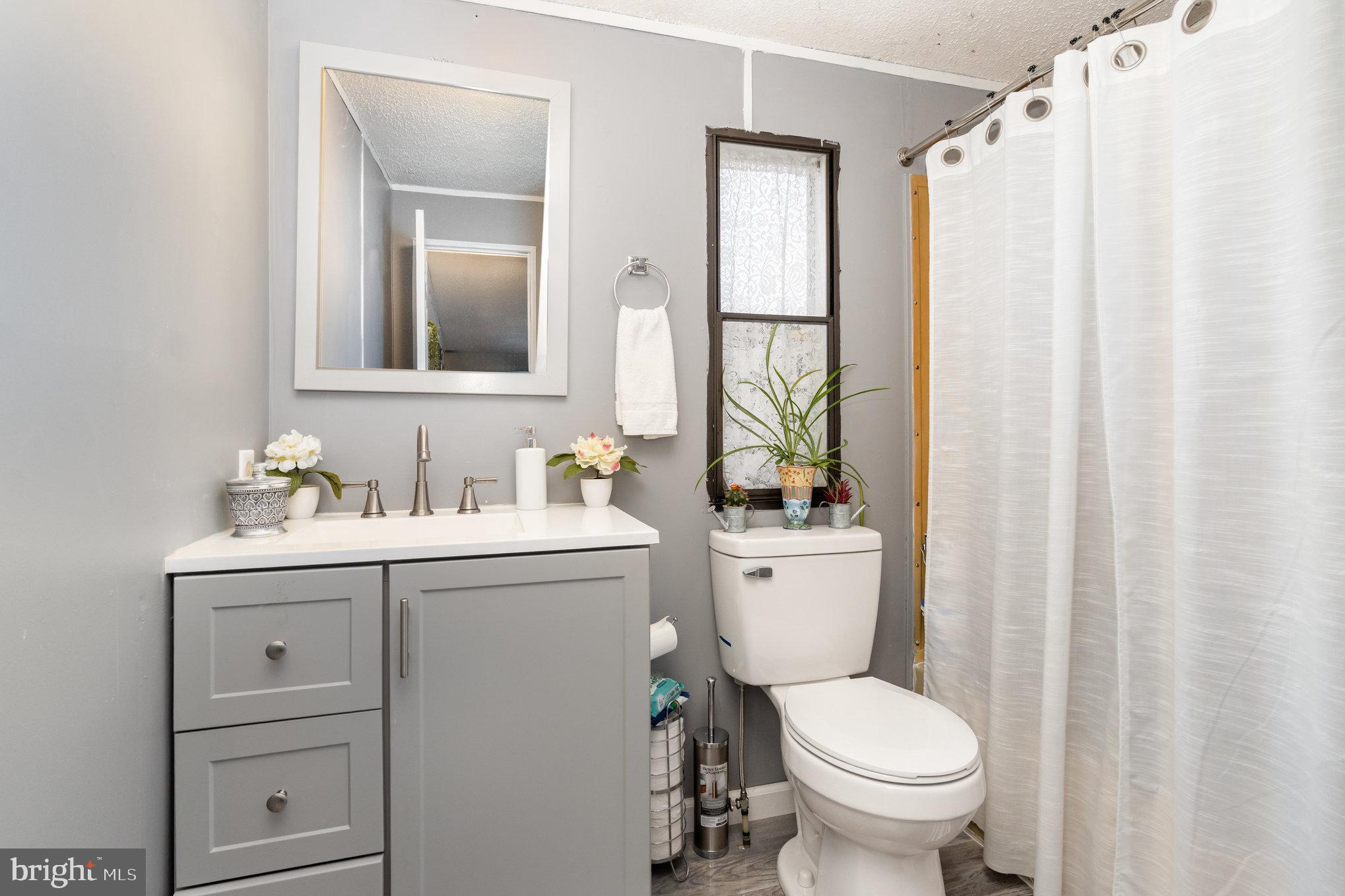 90 Penn Valley Village Lititz, PA 17543 - Photo 21 of 26 a bathroom with a toilet sink and mirror
