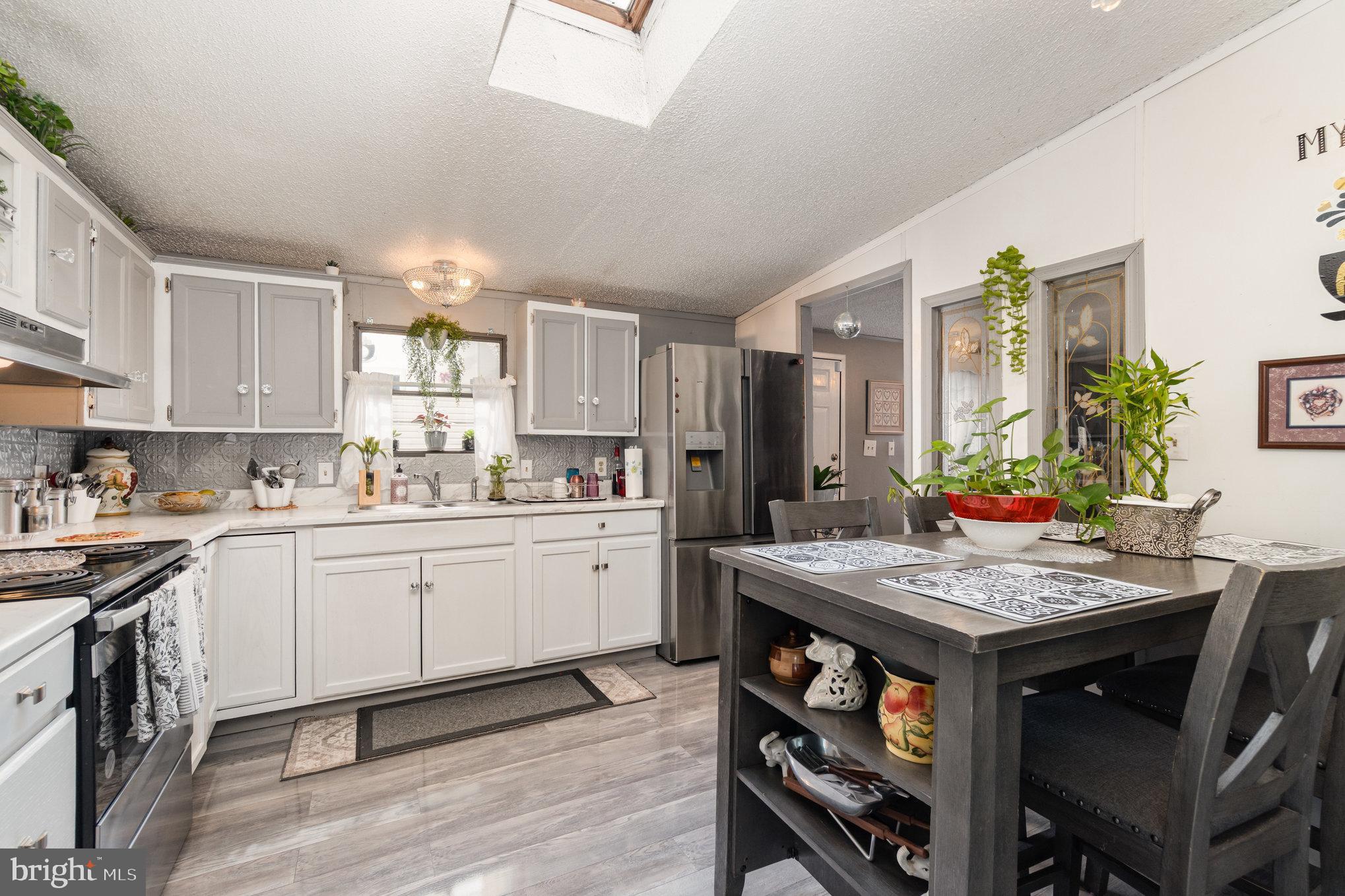 90 Penn Valley Village Lititz, PA 17543 - Photo 9 of 26 a kitchen with a table chairs sink and cabinets
