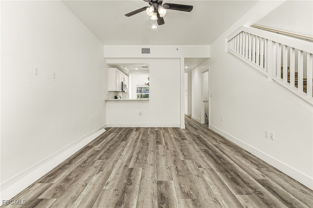 2110 West First Street, Unit 103 Fort Myers, FL 33901 - Photo 11 of 38 wooden floor in an empty room with a window