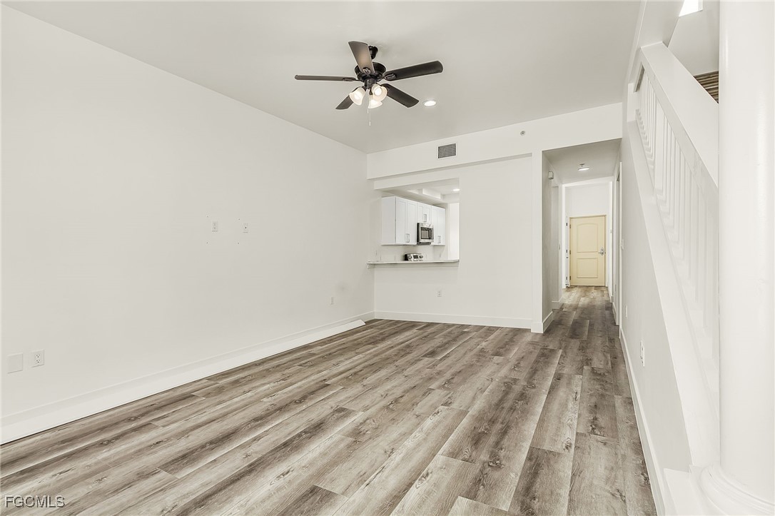 2110 West First Street, Unit 103 Fort Myers, FL 33901 - Photo 12 of 38 wooden floor in an empty room
