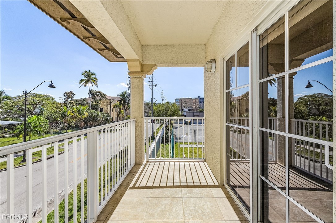2110 West First Street, Unit 103 Fort Myers, FL 33901 - Photo 16 of 38 a view of a balcony with wooden floor and iron fence