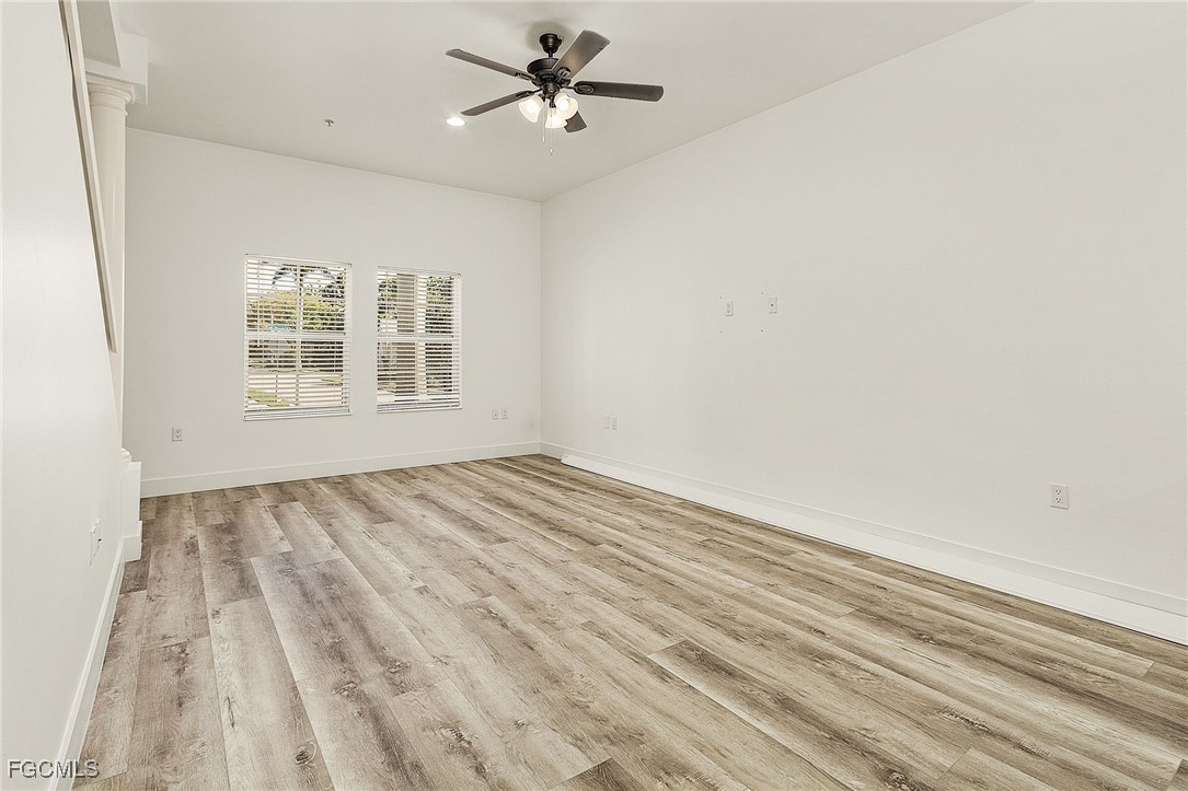2110 West First Street, Unit 103 Fort Myers, FL 33901 - Photo 10 of 38 a view of empty room with wooden floor and fan