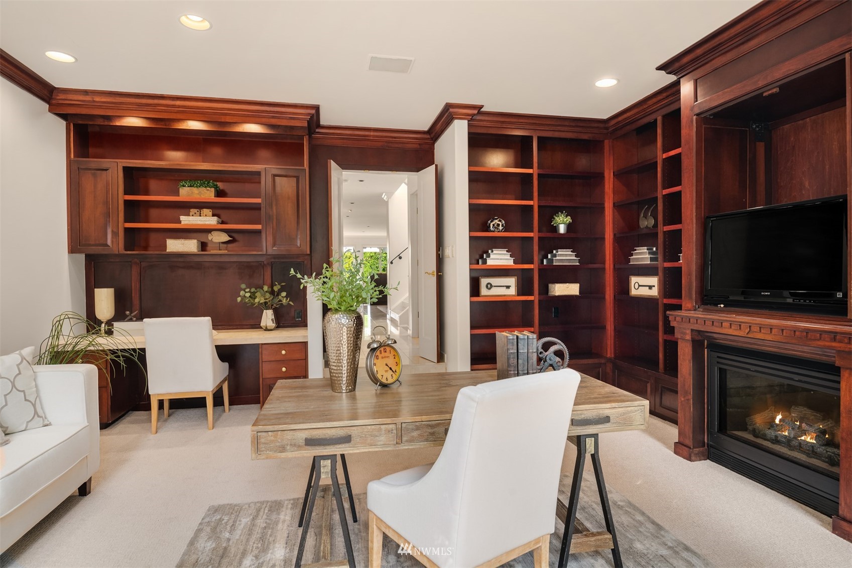 3768 West Commodore Way Seattle, WA 98199 - Photo 13 of 37 a work room with furniture a flat screen tv and a fireplace