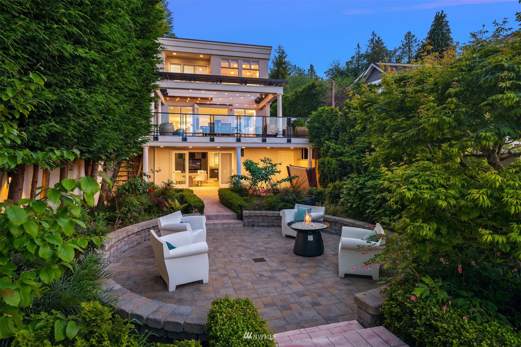3768 West Commodore Way Seattle, WA 98199 - Photo 30 of 37 a view of a patio with table and chairs potted plants and a large tree