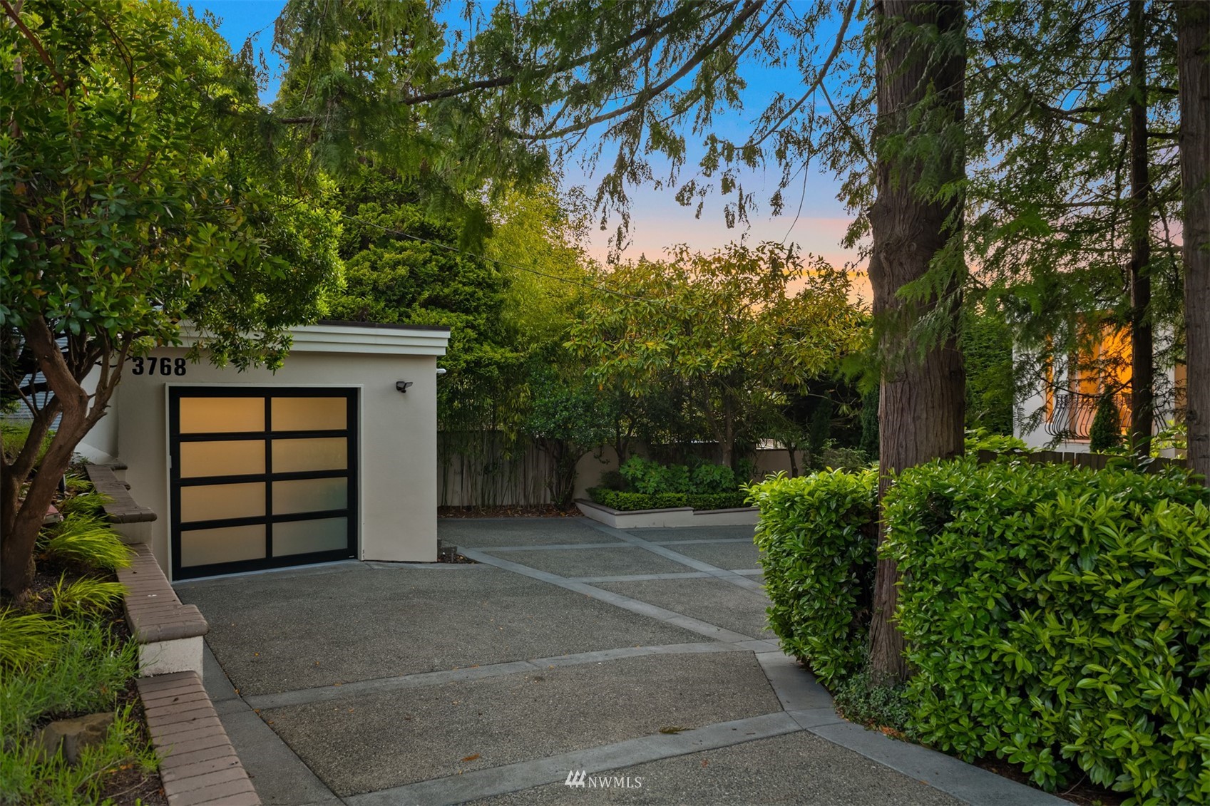3768 West Commodore Way Seattle, WA 98199 - Photo 34 of 37 a front view of a house with a garden