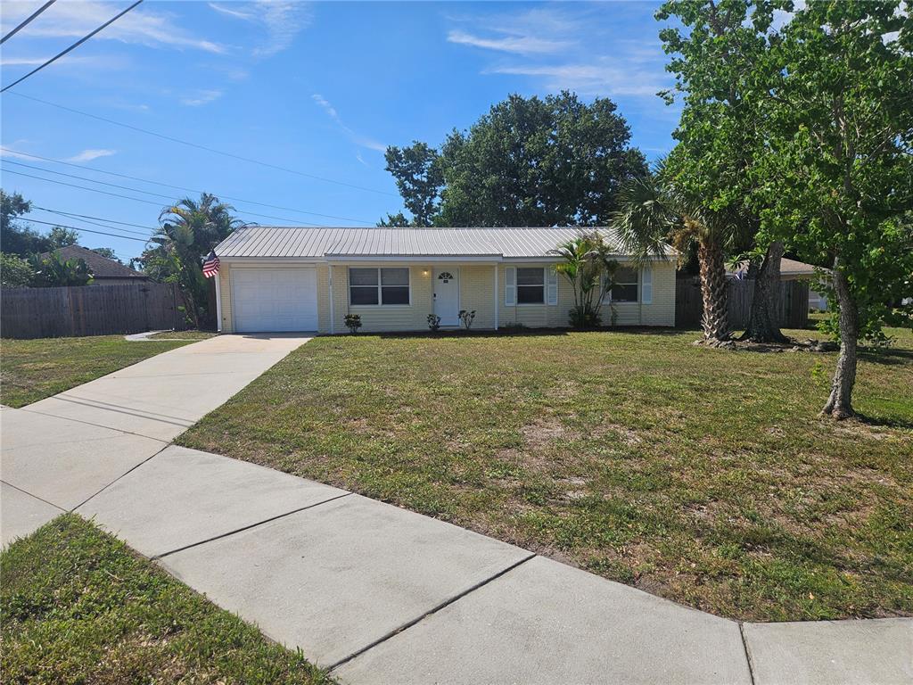 7000 Brentford Road Sarasota, FL 34241 - Photo 1 of 29 a backyard of a house with yard and outdoor seating