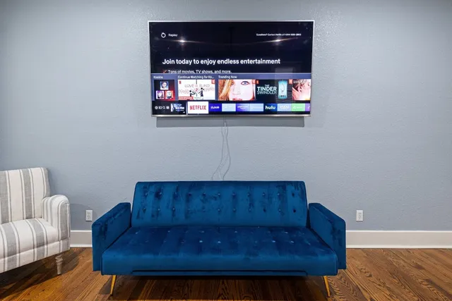a living room with furniture and a wooden floor