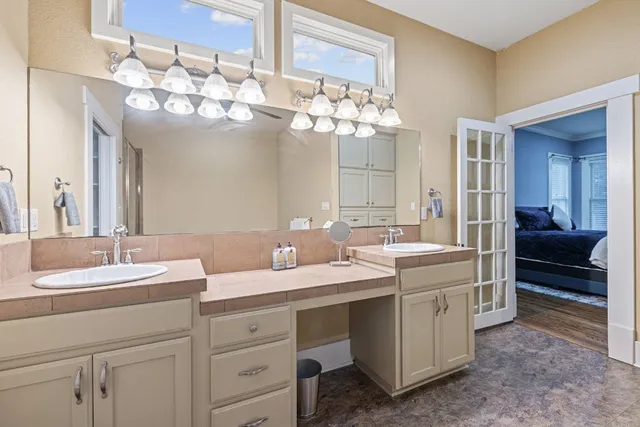 a bathroom with a sink double vanity and a mirror