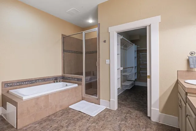 a bathroom with a tub a sink and a view of bathroom