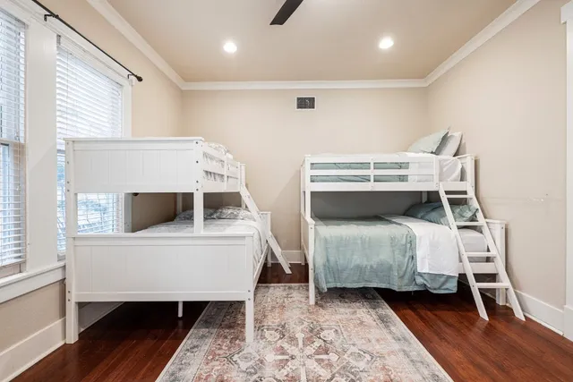 a bedroom with two beds and a chair