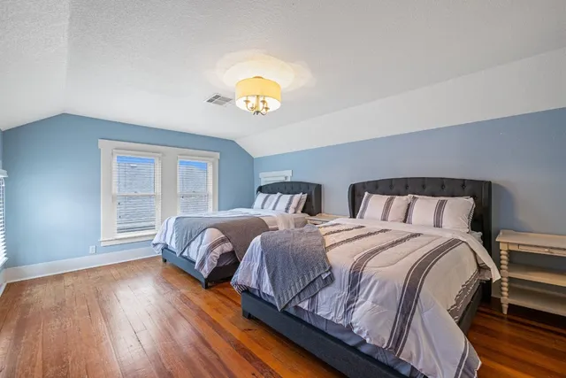 a bedroom with two beds and a window