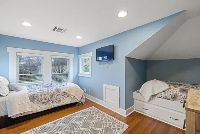 a bedroom with a bed and window