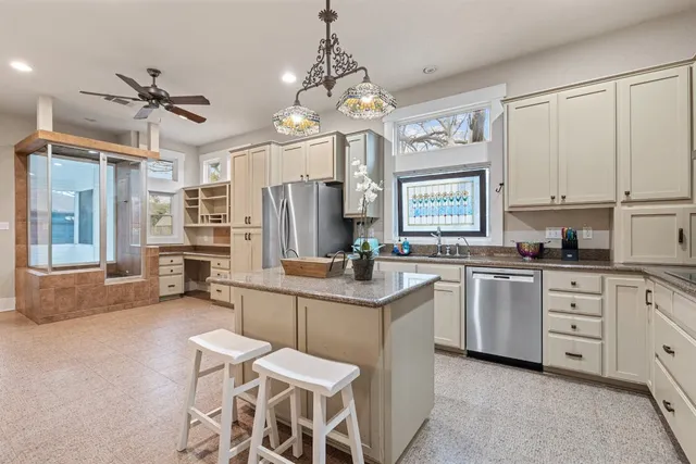 a kitchen that has a lot of cabinets in it
