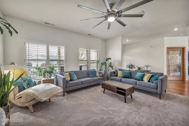 a bedroom with a bed a couch and a window