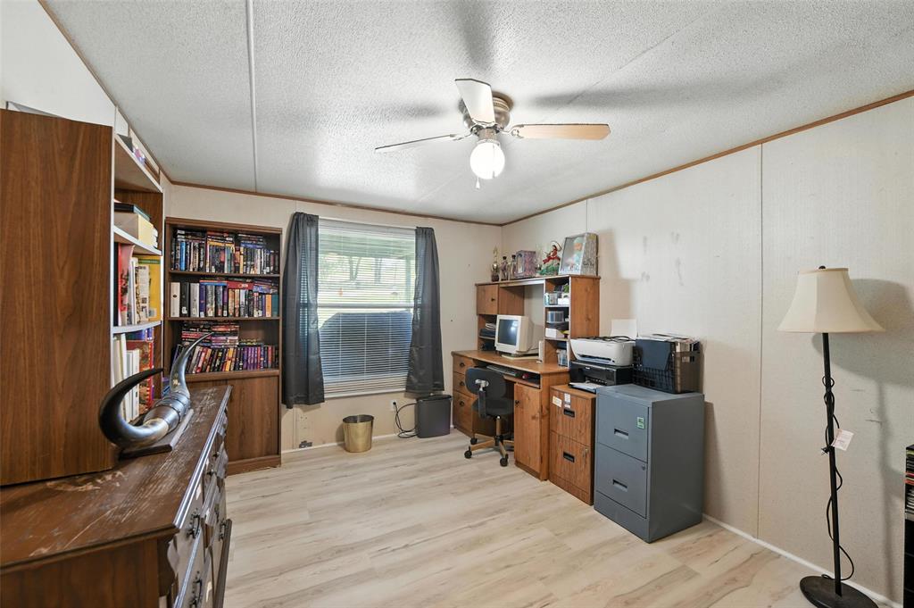 1933 Carter Road Springtown, TX 76082 - Photo 25 of 38 Office space featuring light wood-style flooring, a ceiling fan, and a textured ceiling