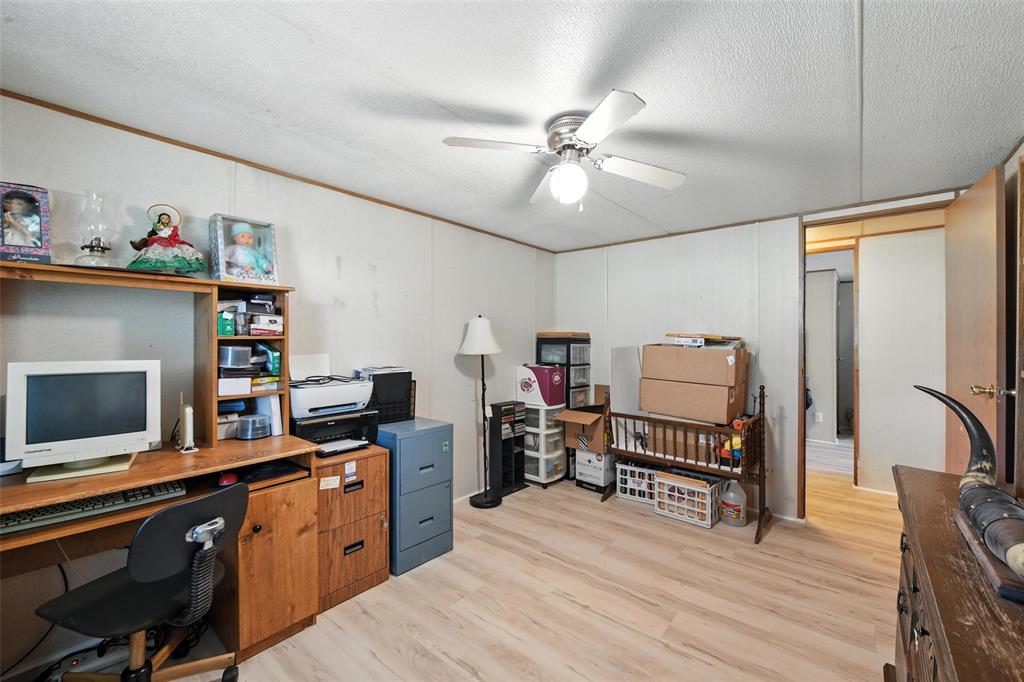1933 Carter Road Springtown, TX 76082 - Photo 26 of 38 Office space featuring ceiling fan, light wood-style flooring, and a textured ceiling