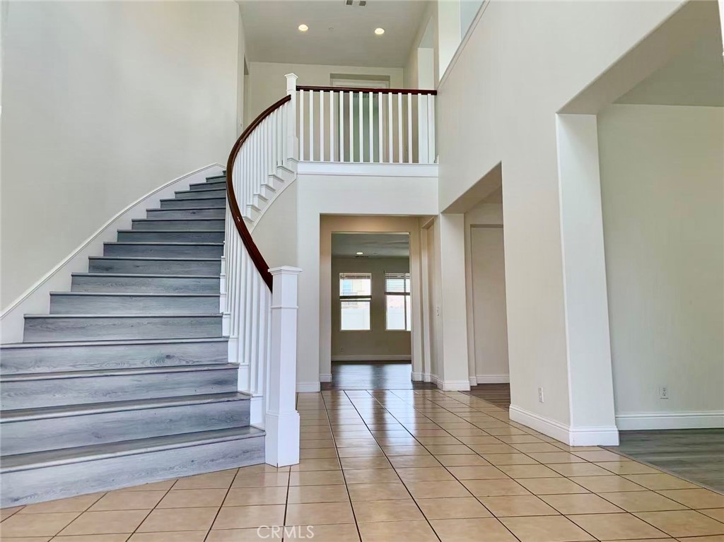 10828 Portofino Lane Riverside, CA 92503 - Photo 3 of 14 a view of entryway with wooden floor and stairs