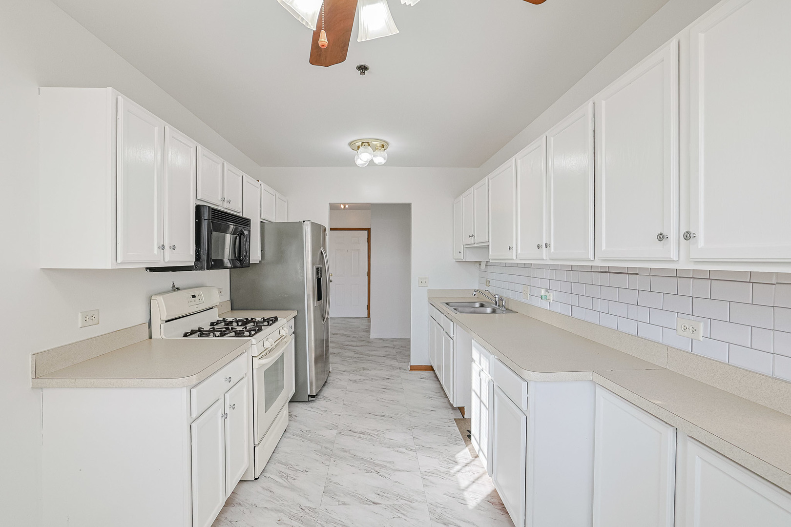 881 North Swift Road, Unit 206 Addison, IL 60101 - Photo 15 of 26 a kitchen with stainless steel appliances granite countertop a sink stove and refrigerator