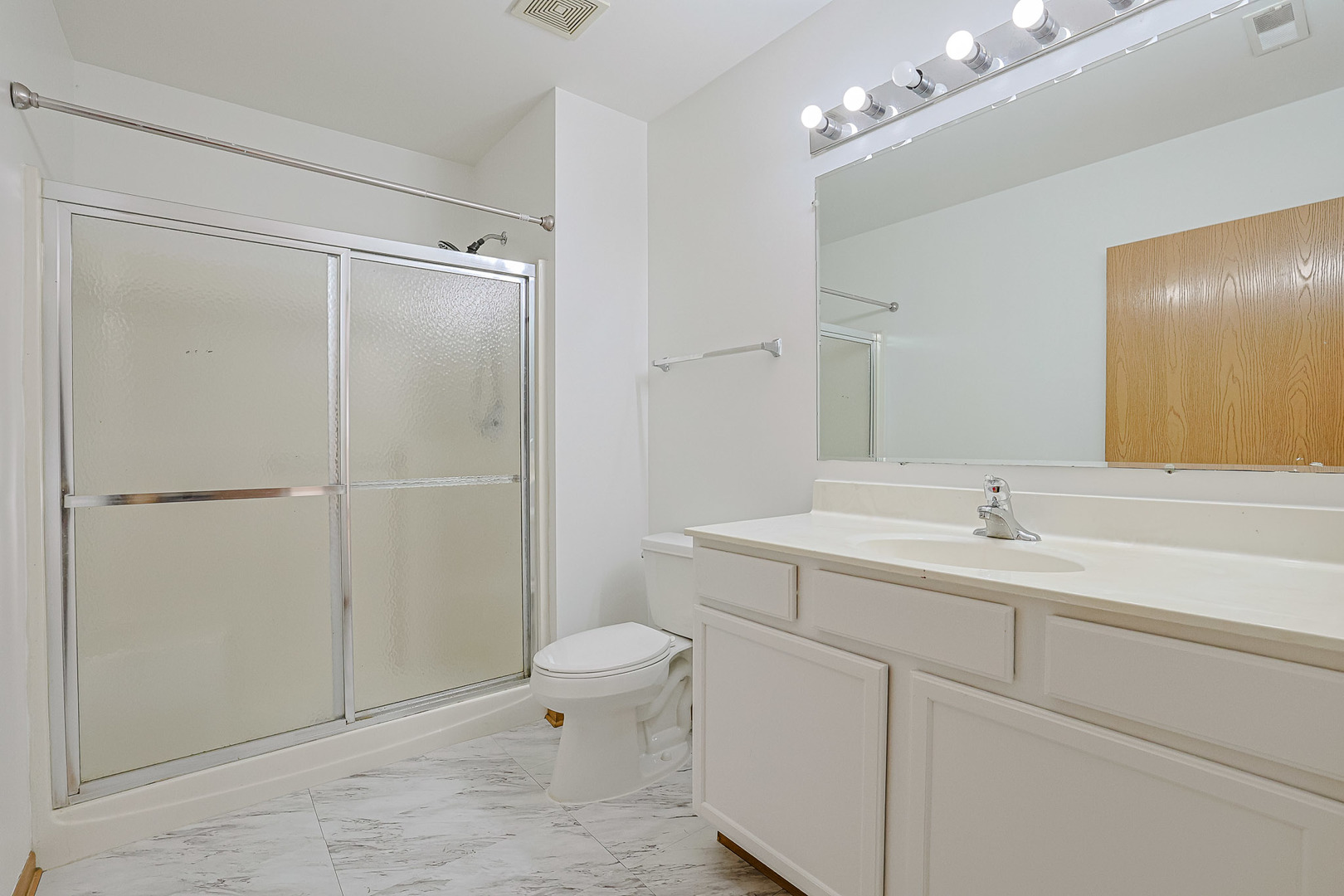 881 North Swift Road, Unit 206 Addison, IL 60101 - Photo 19 of 26 a bathroom with a toilet a sink a mirror and vanity