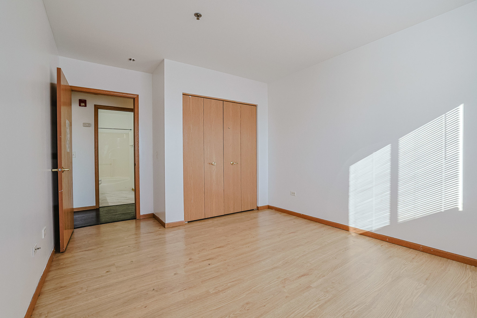 881 North Swift Road, Unit 206 Addison, IL 60101 - Photo 21 of 26 a view of an empty room with wooden floor