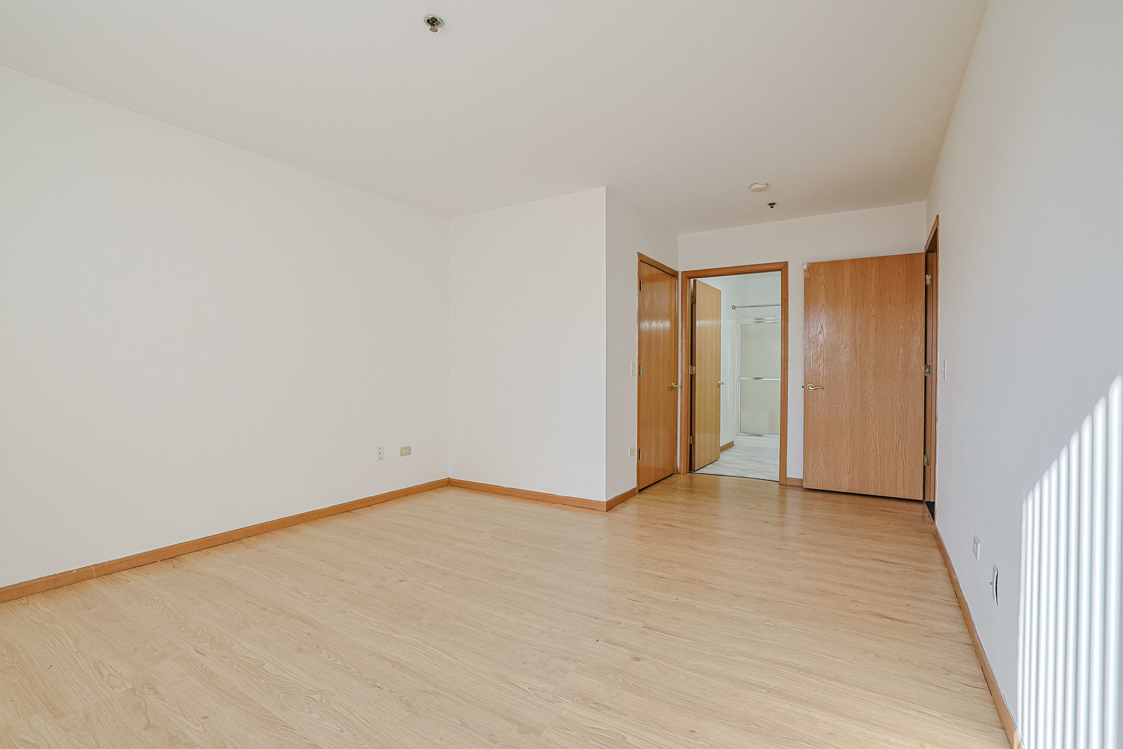 881 North Swift Road, Unit 206 Addison, IL 60101 - Photo 22 of 26 a view of an empty room with wooden floor