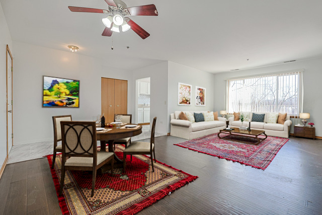 881 North Swift Road, Unit 206 Addison, IL 60101 - Photo 5 of 26 a living room with furniture and a chandelier
