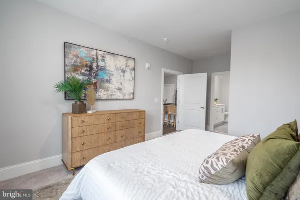 a bedroom with a bed and a potted plant
