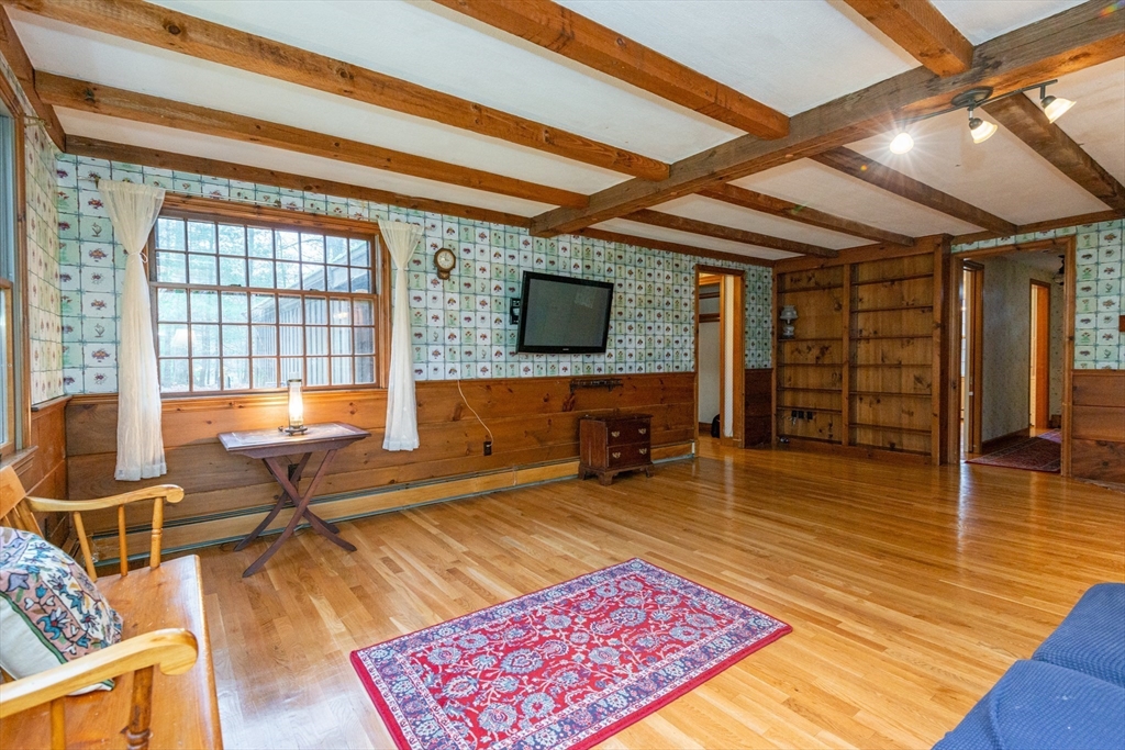 15 Hart Road Lynnfield, MA 01940 - Photo 16 of 40 a living room with furniture a rug and a flat screen tv