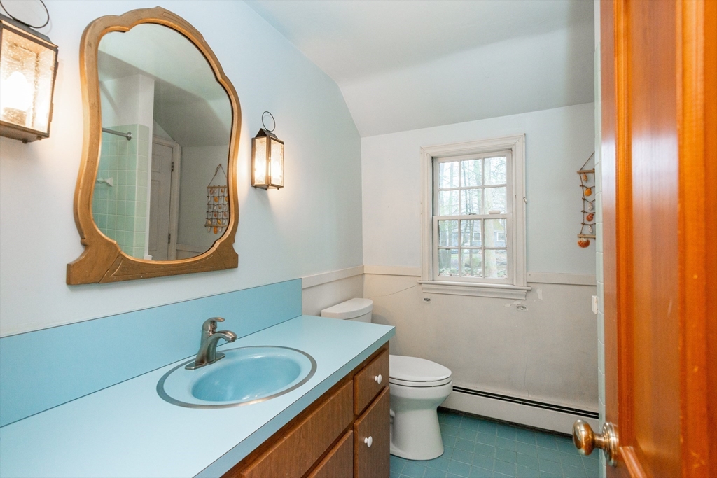 15 Hart Road Lynnfield, MA 01940 - Photo 30 of 40 a bathroom with a toilet sink vanity and mirror